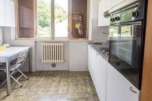 a kitchen with a table and a stove top oven at A28 - Poggio, trilocale vista mare in Ancona