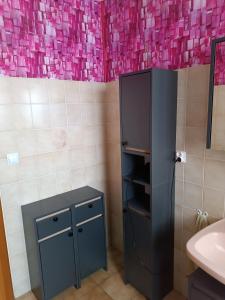 a bathroom with a black refrigerator and a sink at alsacecoeur in Ungersheim