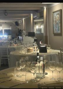 a table with wine glasses on top of it at Villa Marchese Lake Maggiore in Somma Lombardo