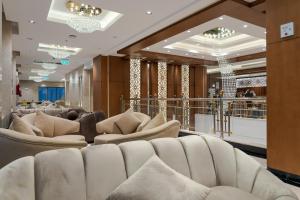 a lobby with a row of white couches at Ancyra Hotel - By Continent - فندق انكيرا in Medina +46 photos