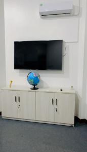 a white cabinet with a television on top of it at Traveler's Cottage in Unawatuna