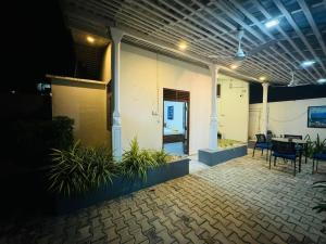 a house with a patio with a table and chairs at Traveler's Cottage in Unawatuna