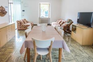 a living room with a table and chairs and a tv at A28 - Poggio, trilocale vista mare in Ancona