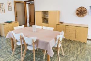 a kitchen with a table and white chairs at A28 - Poggio, trilocale vista mare in Ancona +26 photos