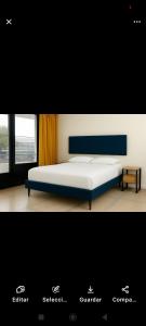 a bedroom with a bed and a window at colibrí Hostel in Armenia +7 photos