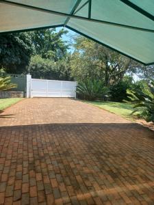 a patio with an umbrella on a brick driveway at The Roaches in White River
