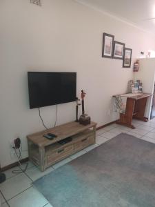 a living room with a flat screen tv on the wall at The Roaches in White River