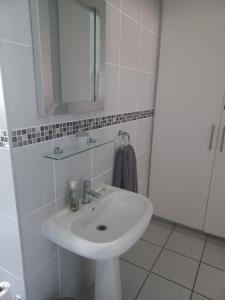 a bathroom with a white sink and a mirror at The Roaches in White River +15 photos