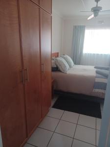 a bedroom with a bed and a cabinet and a window at The Roaches in White River