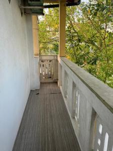 a balcony of a building with trees in the background at Traveler's Cottage in Unawatuna +16 photos