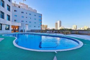 a large swimming pool on the side of a building at Crown Palace Hotel in Ajman 