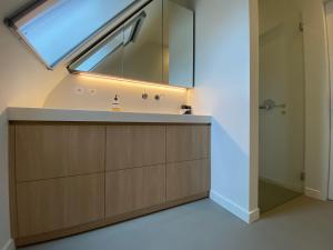 a bathroom with a sink and a large window at Oase d'Itegem - Wellness & Luxe in Heist-op-den-Berg +24 photos