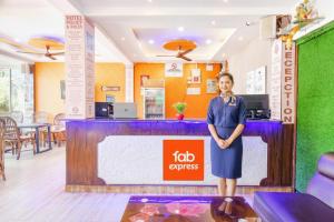 a woman standing in front of a job services counter at Via Shanel Beachside Resort - Tito's lane, Baga Beach in Baga