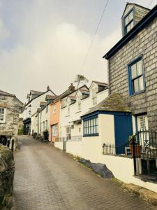 a row of houses on a cobblestone street at Waves End - Port Isaac Cornwall in Port Isaac