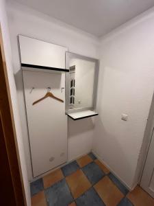 a small room with a closet and a mirror at Ferienwohnung Nähe Autobahn Ruhige Lage für Familien & Monteure in Erolzheim +17 photos