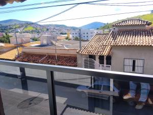 a person standing on the balcony of a house at Casa temporada RA capitolio in Capitólio