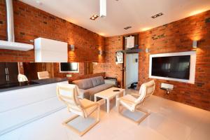 a living room with a brick wall at The Loft in Gliwice
