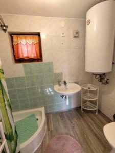 un bagno con un lavandino, una vasca da bagno e un lavandino di BB House a Balatonboglár Altre 16 foto