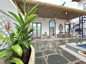 a room with a patio with a pool and a plant at Doc Bien Homestay Mui Ne - Entire Home in Ấp Khánh Phước (1)