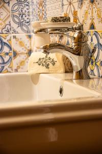 a sink with a faucet in a bathroom at Agriturismo La Frattina in Buonconvento +38 photos