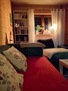 a bedroom with two beds and a book shelf at Osada Bura Polana in Ujsoły