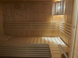 a small wooden sauna with a bench in it at ACQUAMARINA - Home & Relax in Ascoli Satriano