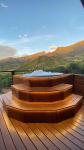 a set of stairs on a deck with mountains in the background at Pousada Café da Mata in Alto Caparao +37 photos