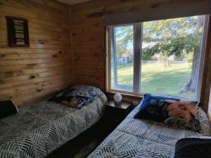 Postel nebo postele na pokoji v ubytování Cabañas El Roble