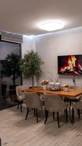 a dining room with a table and a fireplace at ADA MOMENT Splav- kuca na reci Beograd- Floating House on SAVA RIVER ,Belgrade in Belgrade