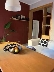 a living room with a table with a bowl of fruit on it at Fuori Arena in Casalecchio di Reno +19 photos