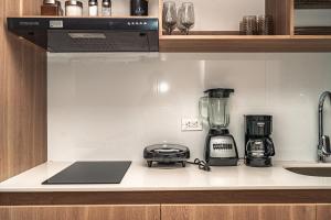 a kitchen counter with a blender and a sink at Modern studio apartment with AC and secure parking in Acacías