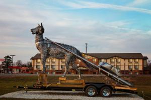 a statue of a dog standing on a trailer at Super 8 by Wyndham Cuba in Cuba