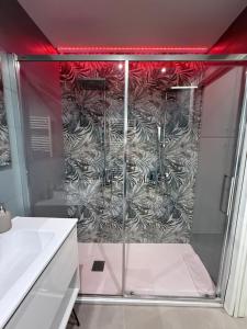 a shower with a glass door in a bathroom at CR Home in Palermo