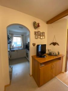 a room with a kitchen with a tv on a counter at Ferienhaus Dengg in Hippach