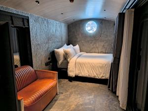 a small room with a bed and a couch at Khanom Station 549 in Ban Na Dan +26 photos