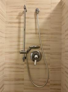 a shower with a hose attached to a wall at Fuori Arena in Casalecchio di Reno