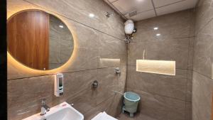 a bathroom with a sink and a mirror at Hotel Radhe in Junagadh