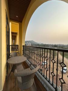 a balcony with a table and chairs on a balcony at Aijasvan Resort in Sawāi Mādhopur