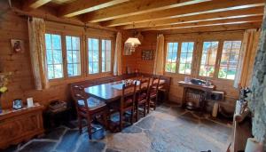 a dining room with a wooden table and chairs at Chalet Famicha by Jolidi in Nendaz +12 photos