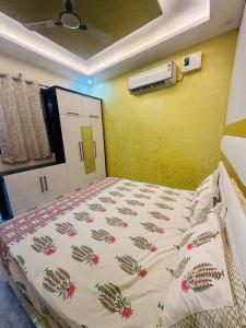 a bedroom with a bed with a comforter on it at Cloud in Karnāl