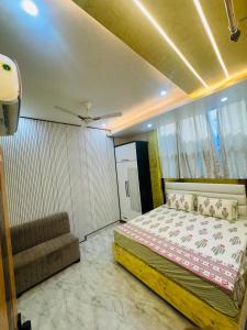 a bedroom with a bed and a couch in it at Cloud in Karnāl