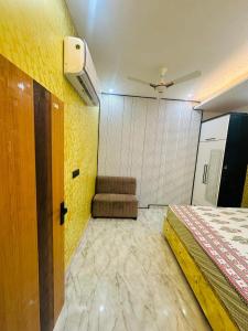 a bedroom with a bed and a ceiling fan at Cloud in Karnāl