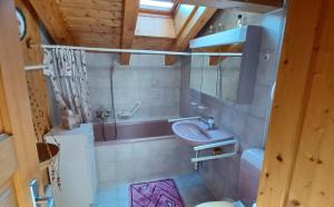 a bathroom with a sink and a toilet and a mirror at Chalet Famicha by Jolidi in Nendaz