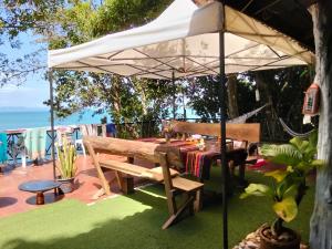 a picnic table under an umbrella on a patio at Island Life Bungalows in Ko Khan