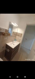 a bathroom with a sink and a mirror at ALMAREDo in Bisceglie