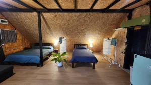 a bedroom with two beds in a room with a ceiling at Seven 50s in Pai +65 photos