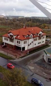a large white house with a red roof at Alabastro in Tomaszów Mazowiecki