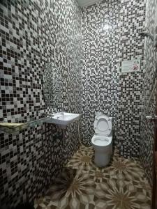 a bathroom with a toilet and a sink at Good Day Kampot Guesthouse in Kampot