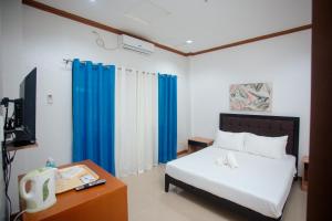 Ένα ή περισσότερα κρεβάτια σε δωμάτιο στο RGE Hotel