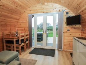 a living room with a sliding glass door in a cabin at Willow in Ulverston